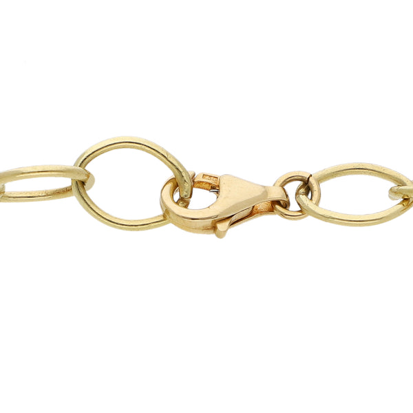 Pulsera eslabón cruzado con colgantes firma Tous motivo figuras diferentes y sintéticos en oro amarillo 18 kilates.