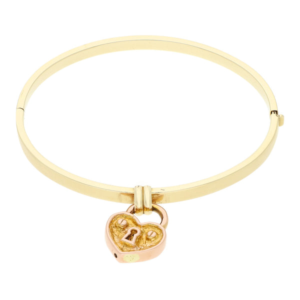 Pulsera de arillo articulada con colgante motivo corazón con candado en oro dos tonos 14 kilates.