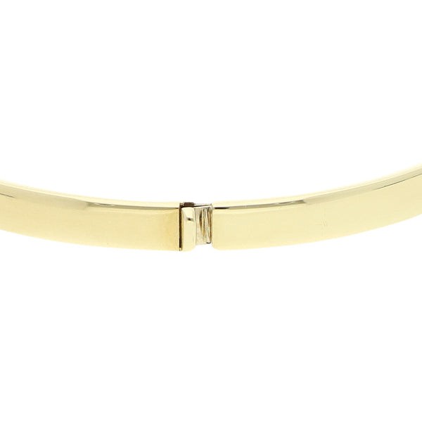 Pulsera de arillo articulada con colgante motivo corazón con candado en oro dos tonos 14 kilates.