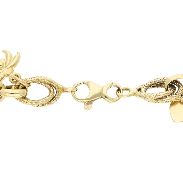 Pulsera eslabón cruzado con colgantes motivo diferentes figuras en oro amarillo 14 kilates.