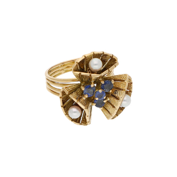 Anillo diseño especial con sintéticos en oro amarillo 18 kilates.