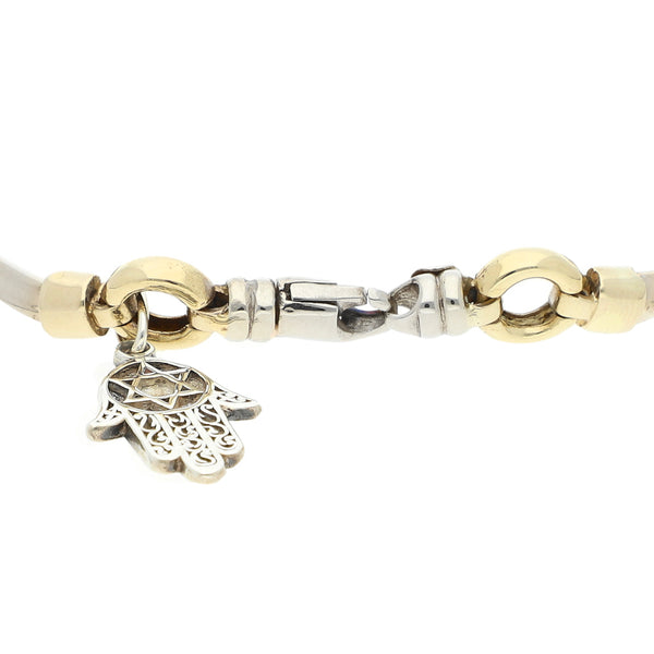Pulsera eslabón articulado, con colgante motivo mano en oro dos tonos 14 kilates.