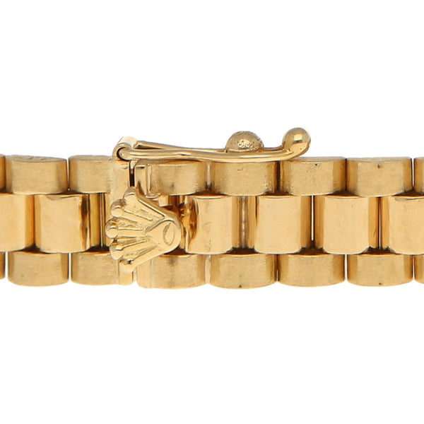 Pulsera eslabón articulado con aplicación motivo corona en oro amarillo 14 kilates