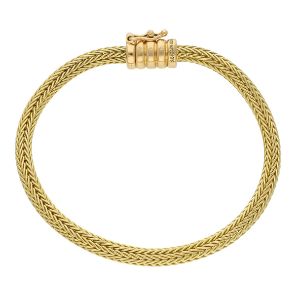 Pulsera eslabón tejido firma Tane en oro amarillo 18 kilates.
