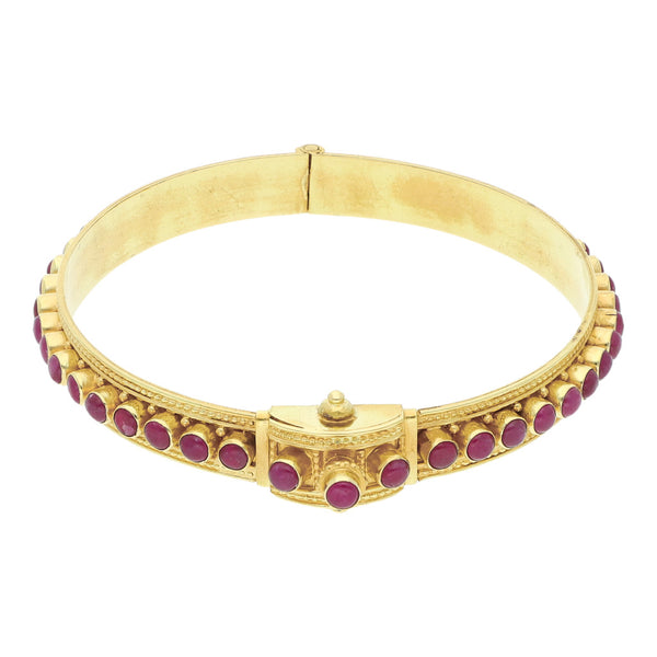 Pulsera de arillo articulada con rubíes en oro amarillo 18 kilates.