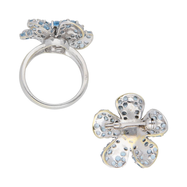 Juego de anillo y prendedor diseño especial motivo flor con sintéticos en oro blanco 18 kilates.