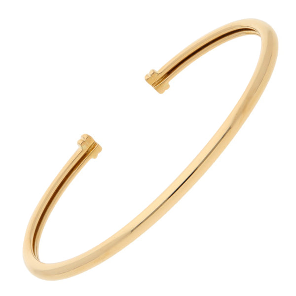 Pulsera de arillo abierta firma Tane en oro amarillo 18 kilates.