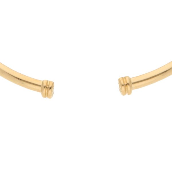 Pulsera de arillo abierta firma Tane en oro amarillo 18 kilates.