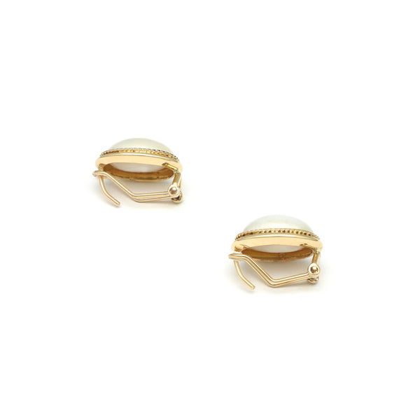 Aretes torzal con media perla en oro amarillo 14 kilates.