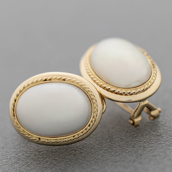 Aretes torzal con media perla en oro amarillo 14 kilates.