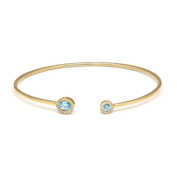 Pulsera de arillo abierta en con diamantes y aguamarina en oro amarillo 14 kilates.