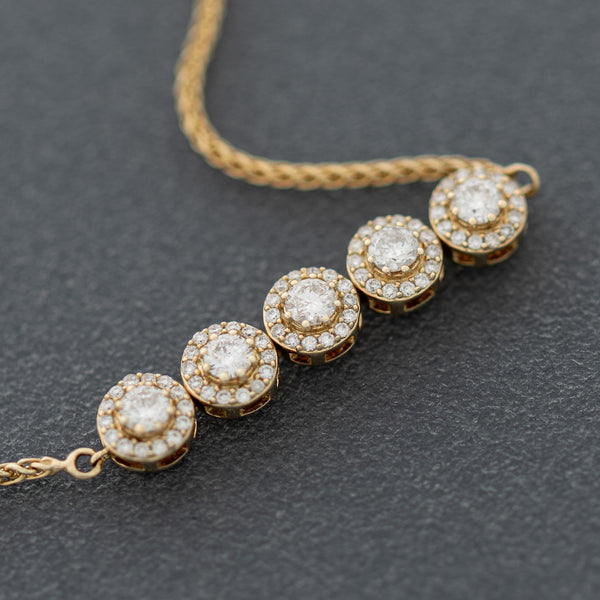 Pulsera eslabón tejido con aplicación de diamantes en oro amarillo 14 kilates.