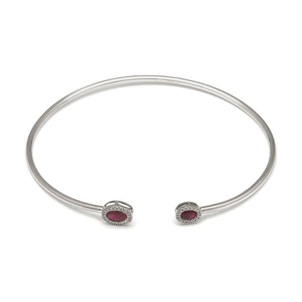 Pulsera de arillo abierta con diamantes y rubíes en oro blanco 14 kilates.