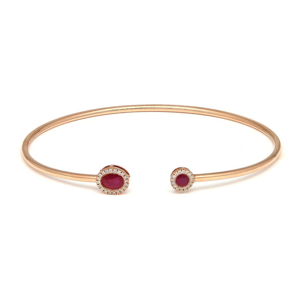 Pulsera de arillo abierta con diamantes y rubíes en oro rosa 14 kilates.
