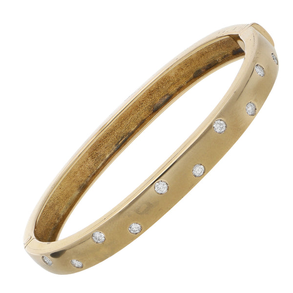 Pulsera de arillo articulada con diamantes en oro amarillo 14 kilates.