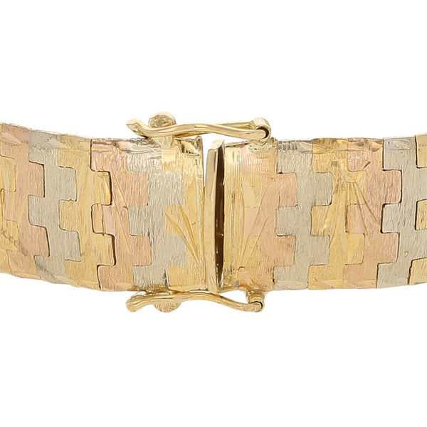 Pulsera eslabón articulado en oro tres tonos 18 kilates.