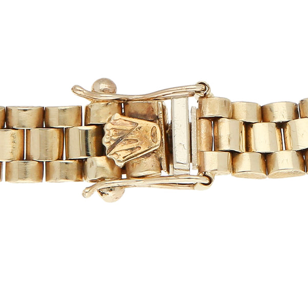 Pulsera eslabón articulado con aplicación motivo corona en oro amarillo 14 kilates.