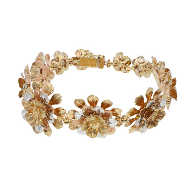 Pulsera eslabón laminado motivo flores en oro tres tonos 14 kilates.