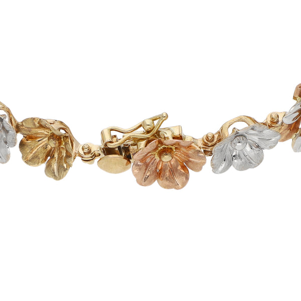 Pulsera eslabón laminado motivo flores en oro tres tonos 14 kilates.