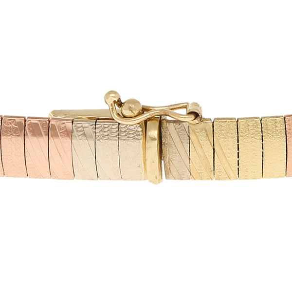 Pulsera eslabón laminado en oro tres tonos 14 kilates.