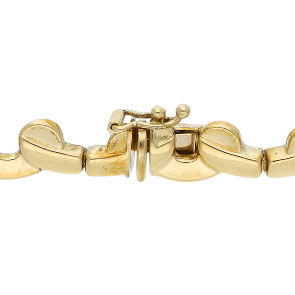 Pulsera eslabón articulado con sintéticos en oro dos tonos 18 kilates.