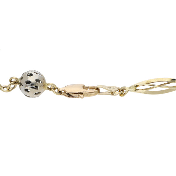 Pulsera eslabón combinado con aplicaciones motivo esferas en oro tres tonos 14 kilates.