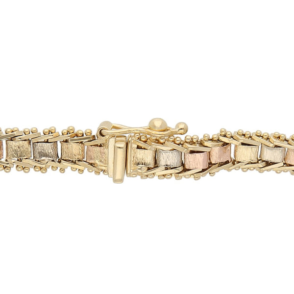 Pulsera eslabón boleado en oro tres tonos 14 kilates.