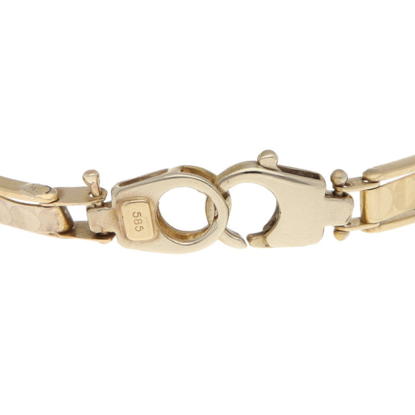 Pulsera eslabón articulado en oro dos tonos 14 kilates.