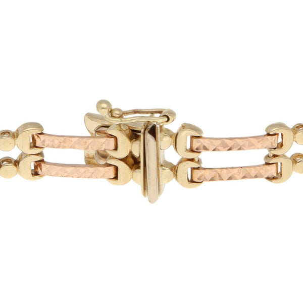 Pulsera eslabón articulado en oro tres tonos 14 kilates.