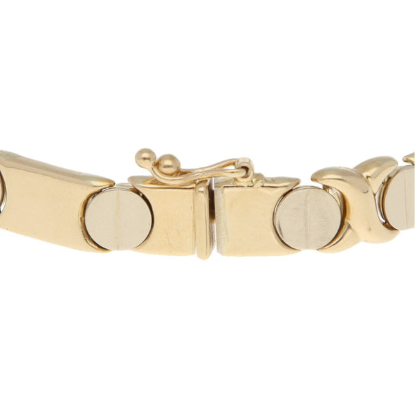 Pulsera eslabón articulado motivo tornillos en oro dos tonos 14 kilates.