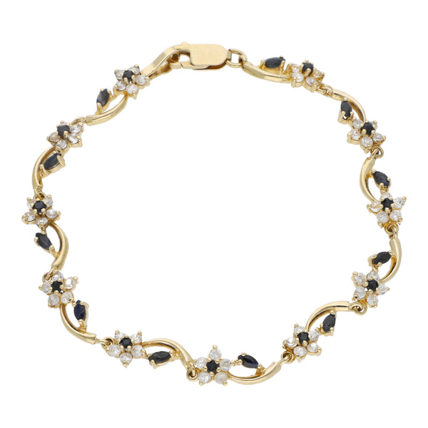 Pulsera eslabón articulado motivo flor con circonias en oro amarillo 14 kilates.