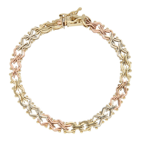 Pulsera eslabón articulado en oro tres tonos 14 kilates.