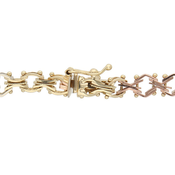 Pulsera eslabón articulado en oro tres tonos 14 kilates.