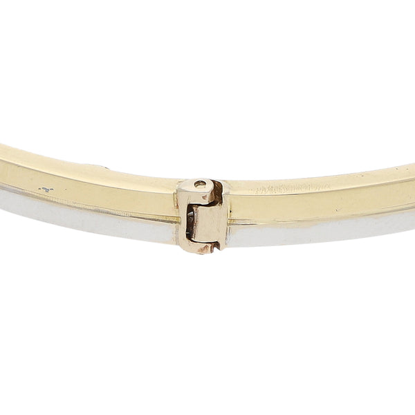 Pulsera de arillo de dos hilos articulada en oro dos tonos 14 kilates.
