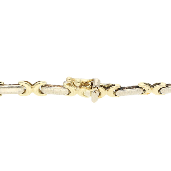Pulsera eslabón articulado en oro dos tonos 14 kilates.