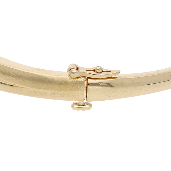 Pulsera de arillo articulada con diamantes en oro amarillo 14 kilates.