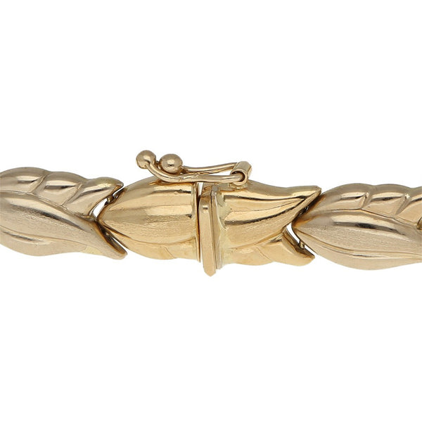Pulsera eslabón articulado motivo flor en oro amarillo 14 kilates.