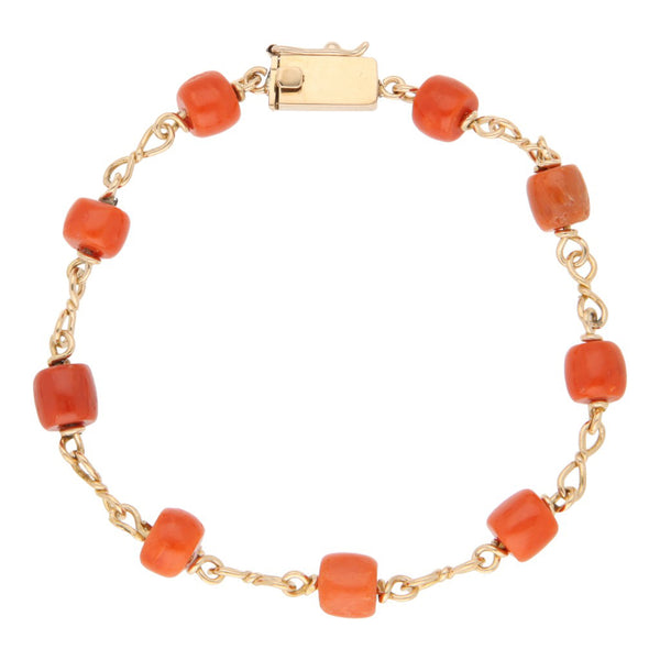 Pulsera eslabón combinado con aplicaciones de coral en oro amarillo 18 kilates.