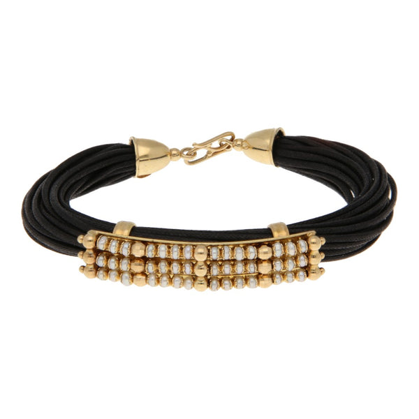 Pulsera textil con aplicaciones casquillos y broche con perlas en oro amarillo 14 kilates.