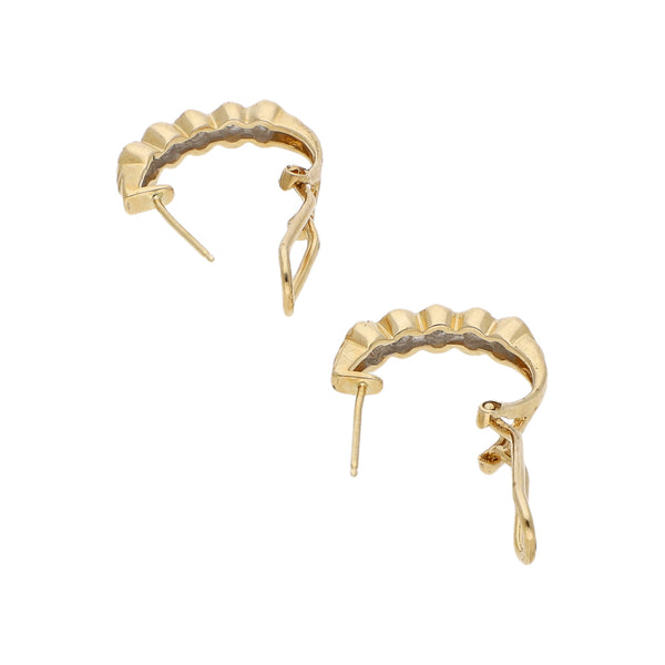Aretes diseño especial con diamantes en oro amarillo 14 kilates.