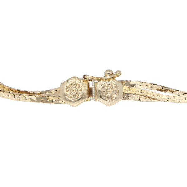 Pulsera de tres hilos eslabón planchado en oro amarillo 14 kilates.