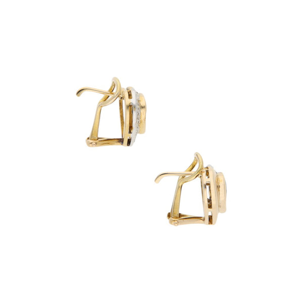 Aretes diseño especial motivo corazón con diamantes y sintético en oro amarillo 12 kilates.