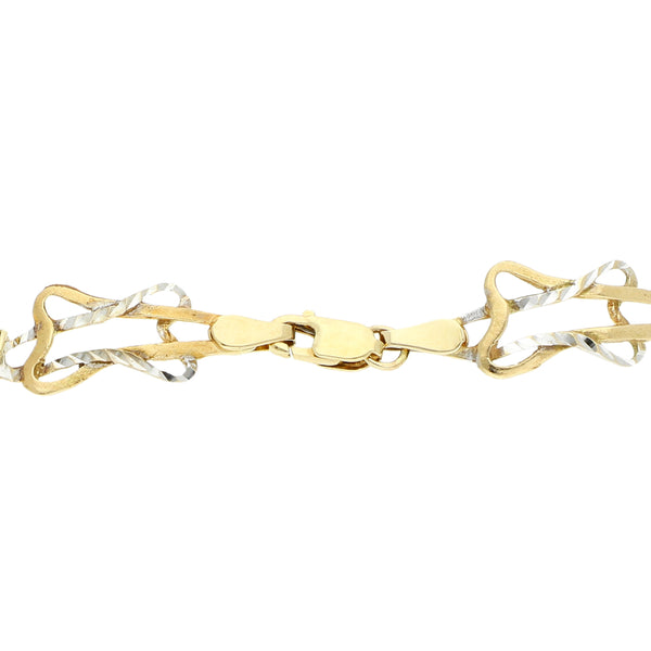Pulsera eslabón combinado motivo estrella en oro dos tonos 14 kilates.