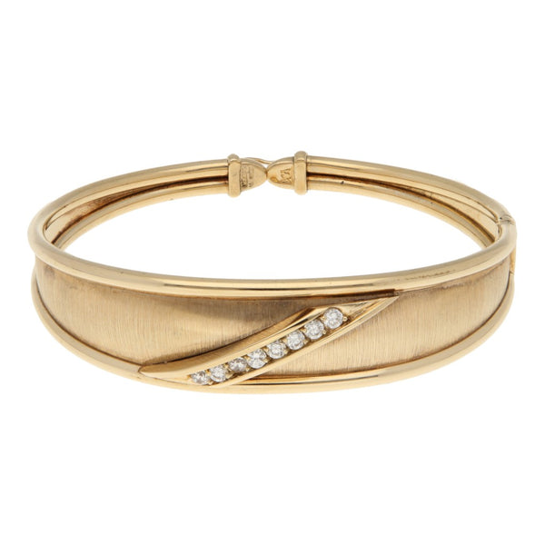 Pulsera de arillo articulada con circonias en oro amarillo 14 kilates.