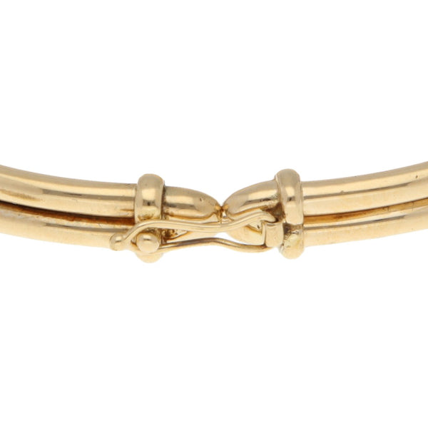 Pulsera de arillo articulada con circonias en oro amarillo 14 kilates.