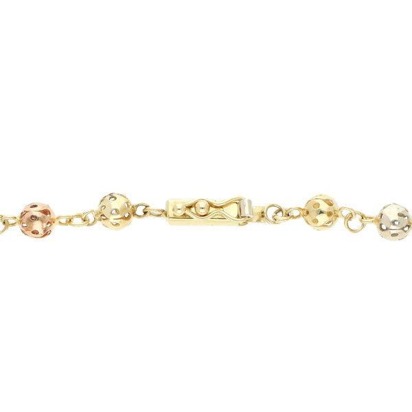 Pulsera eslabón cruzado con aplicaciones motivo esferas en oro tres tonos 14 kilates.