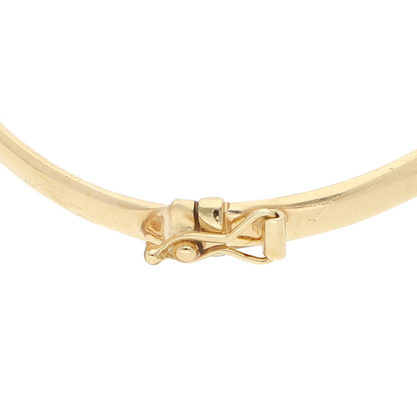 Pulsera de arillo articulada con aplicación motivo tortuga y rubíes en oro tres tonos 14 kilates.