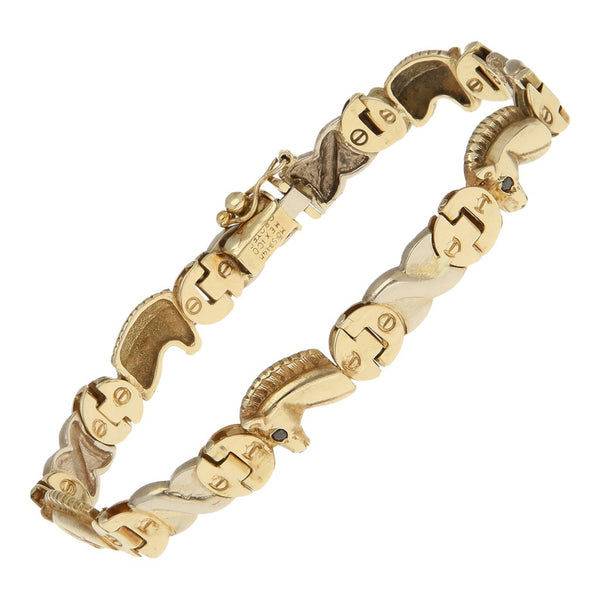 Pulsera eslabón articulado motivo caballos con ónix en oro dos tonos 14 kilates.