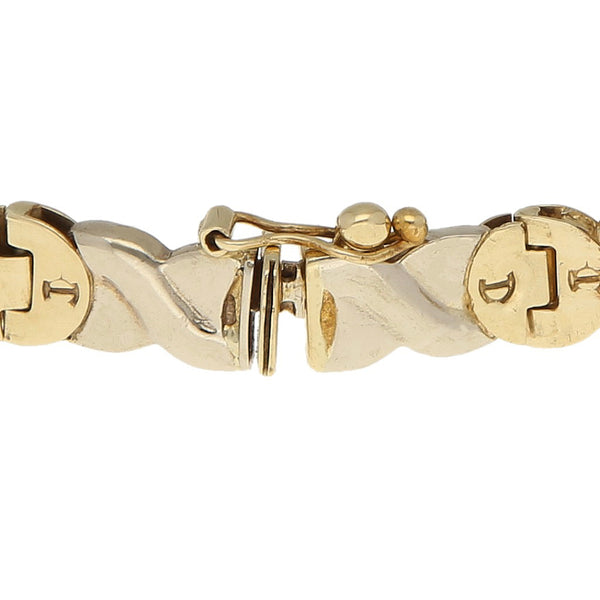 Pulsera eslabón articulado motivo caballos con ónix en oro dos tonos 14 kilates.