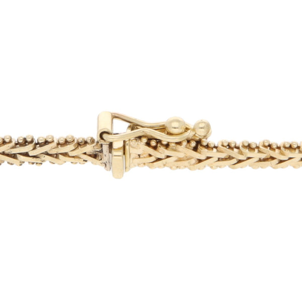 Pulsera eslabón boleado con aplicaciones en oro tres tonos 14 kilates.
